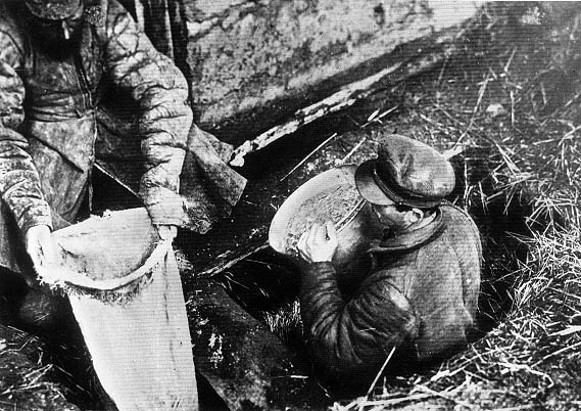 Image - Soviet officials confiscate grain from a peasant household in Ukraine (early 1930s).